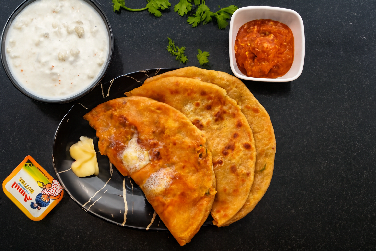 Aloo parathas served with accompaniments